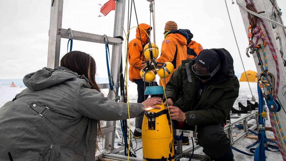 PHOTO: Scientists work in the field at the Thwaites Glacier in Antarctica.