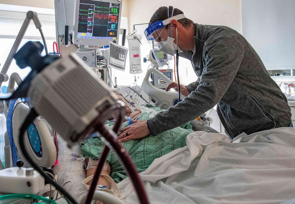 PHOTO: Dr. James Samuel Pope treats a patient who is suffering from COVID-19 in the ICU at Hartford Hospital, in Hartford, Conn. on Jan. 18, 2022.