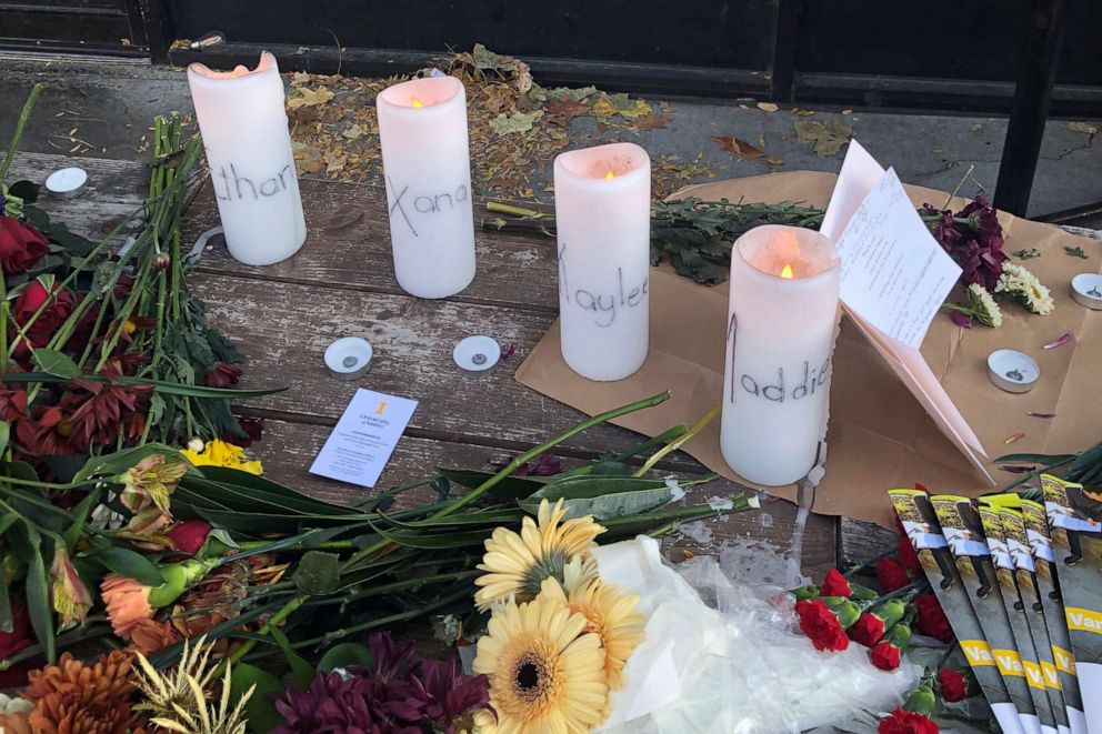 PHOTO: Candles and flowers are left at a make-shift memorial honoring four slain University of Idaho students in downtown Moscow, Idaho, on Nov. 15, 2022