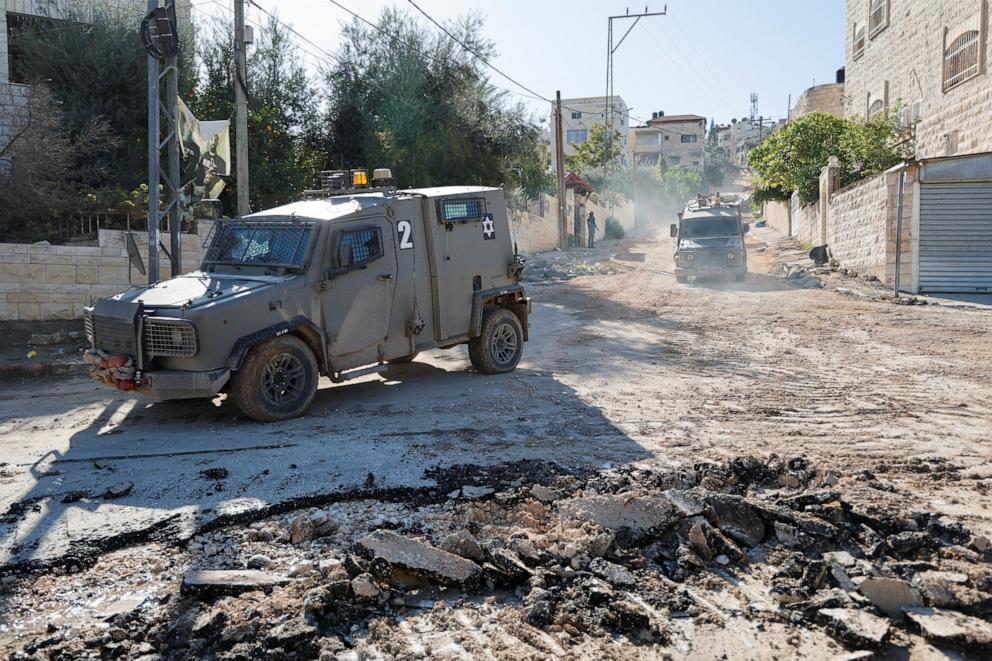 PHOTO: An Israeli military vehicle maneuvers on a road during a raid in Jenin in the Israeli-occupied West Bank, Nov. 29, 2023.