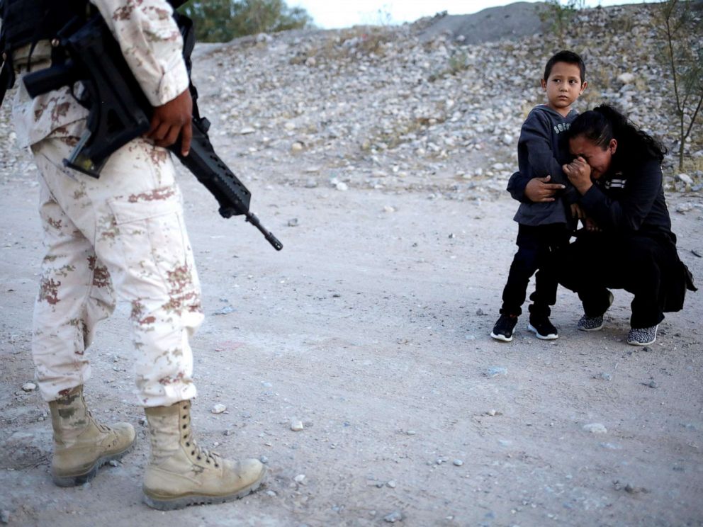 PHOTO: Guatemalan migrant Lety Perez embraces her son Anthony while praying to ask a member of the Mexican National Guard to let them cross into the United States, as seen from Ciudad Juarez, Mexico, July 22, 2019. 