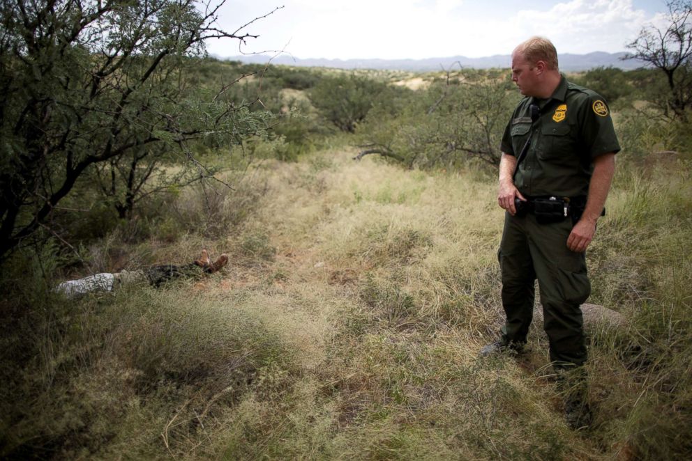Border Patrol Agent Jacob Stukenberg looks at Guatemalan migrant Misael Paiz, 25, who died in the Sonoran Desert after traveling to cross the U.S.-Mexico border, on the Buenos Aires National Wildlife Refuge in Pima County, Arizona, U.S., Sept. 10, 2018.