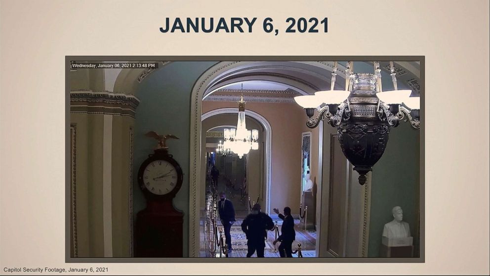 House impeachment manager Del. Stacey Plaskett showed this image from U.S. Capitol security video, Feb. 10, 2021, in Washington of Capitol Police officer Eugene Goodman running past Sen. Mitt Romney after redirecting Romney away from rioters on Jan. 6.