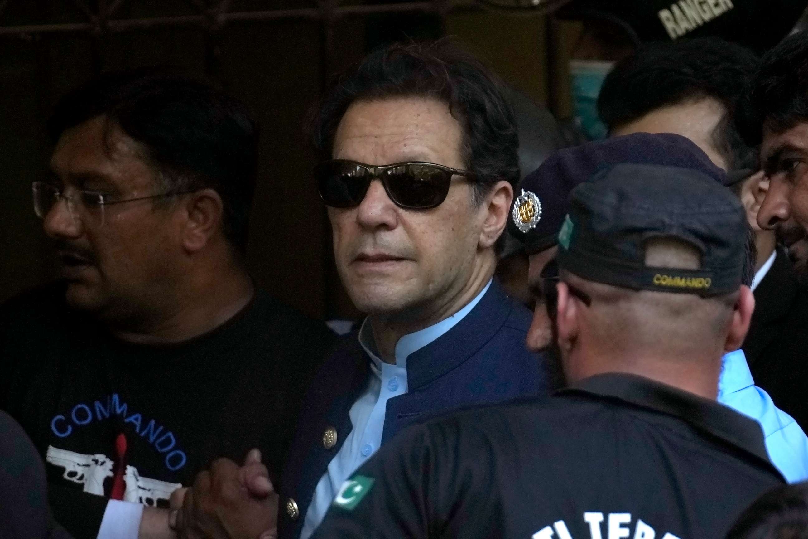 PHOTO: Pakistan's former Prime Minister Imran Khan, center, is escorted by security officials as he arrives to appear in a court, in Islamabad, Pakistan, Friday, May 12, 2023.