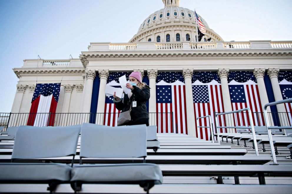 PHOTO: A Joint Congressional Committee on Inaugural Ceremonies volunteer prepares name tags for seats as final preparations are made ahead of the inauguration of President-elect Joe Biden on the West Front of the Capitol on Jan. 20, 2021, in Washington.