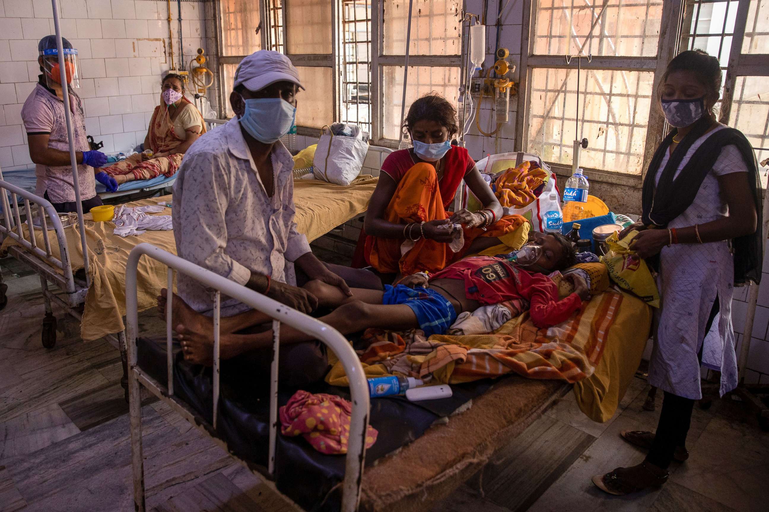 PHOTO: A patient suffering from diabetes lies on a hospital bed as his family look after him on the emergency ward of Jawahar Lal Nehru Medical College and Hospital, in Bhagalpur, Bihar, India, July 26, 2020.