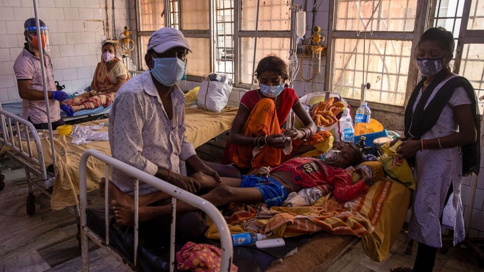 PHOTO: A patient suffering from diabetes lies on a hospital bed as his family look after him on the emergency ward of Jawahar Lal Nehru Medical College and Hospital, in Bhagalpur, Bihar, India, July 26, 2020.