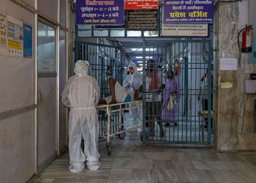 PHOTO: Medical workers Sameer, 22, and his colleague move a COVID-19 patient at the Jawahar Lal Nehru Medical College and Hospital, during the coronavirus disease (COVID-19) outbreak, in Bhagalpur, Bihar, India, July 27, 2020.