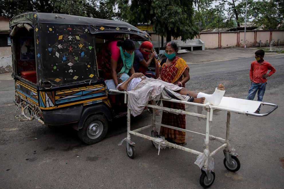 PHOTO: A patient is moved by relatives onto an auto-rickshaw as they take him home after he received treatment at Jawahar Lal Nehru Medical College and Hospital,in Bhagalpur, in Bihar, India, July 27, 2020.