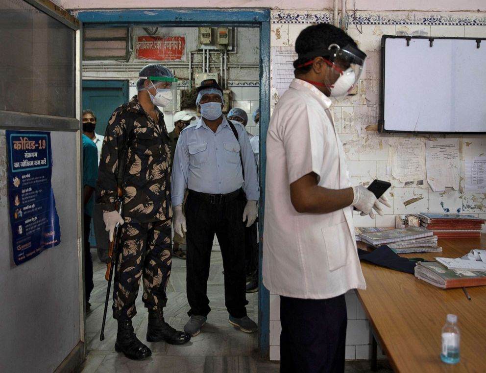 PHOTO: Armed security personnel stand guard as Dr. Kumar Gaurav, 42, a medical professor and consultant psychiatrist who has been named the top official at Jawahar Lal Nehru Medical College and Hospital in Bhagalpur, Bihar, India, July 27, 2020.
