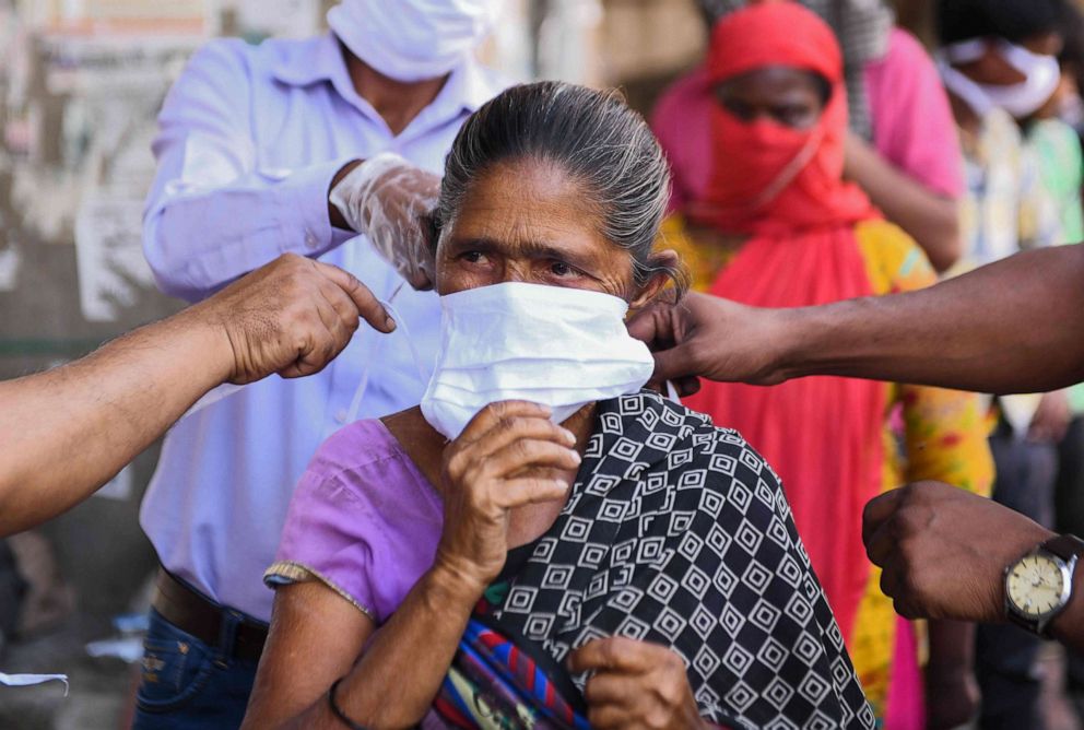 PHOTO: Volunteers of the Diocese of Amritsar Church of North India distribute face masks to people during a government-imposed nationwide lockdown as a preventive measure against the COVID-19 coronavirus, in Amritsar, April 15, 2020. 
