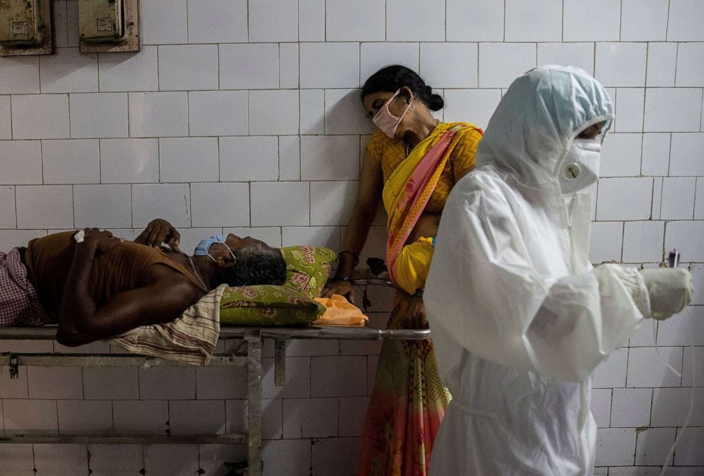 PHOTO: A woman leans against a stretcher holding her husband in the corridor of the emergency ward of Jawahar Lal Nehru Medical College and Hospital, during the coronavirus disease (COVID-19) outbreak.