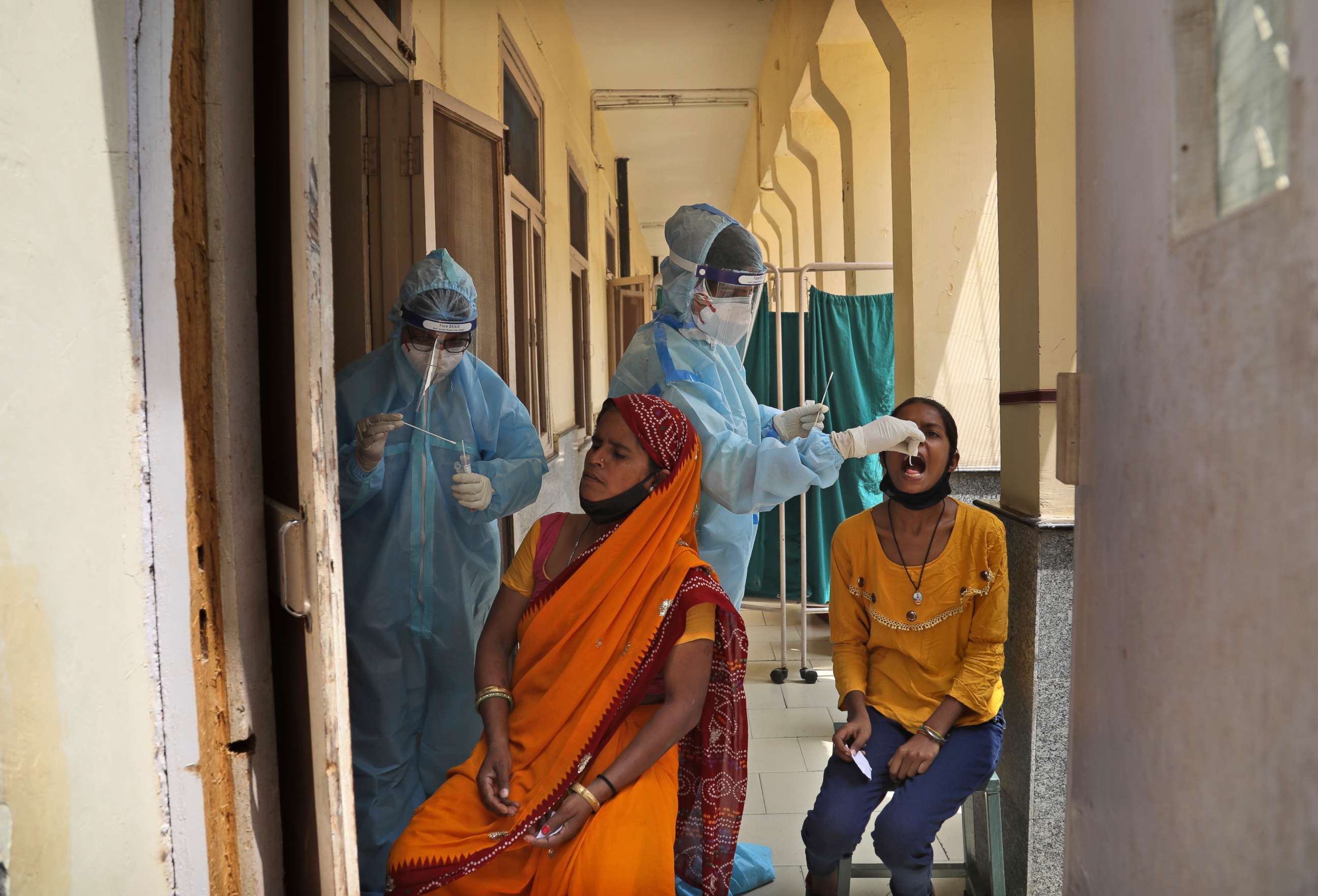 PHOTO: Health workers collect swab samples to test for COVID-19 in New Delhi, India, Friday, April 16, 2021.