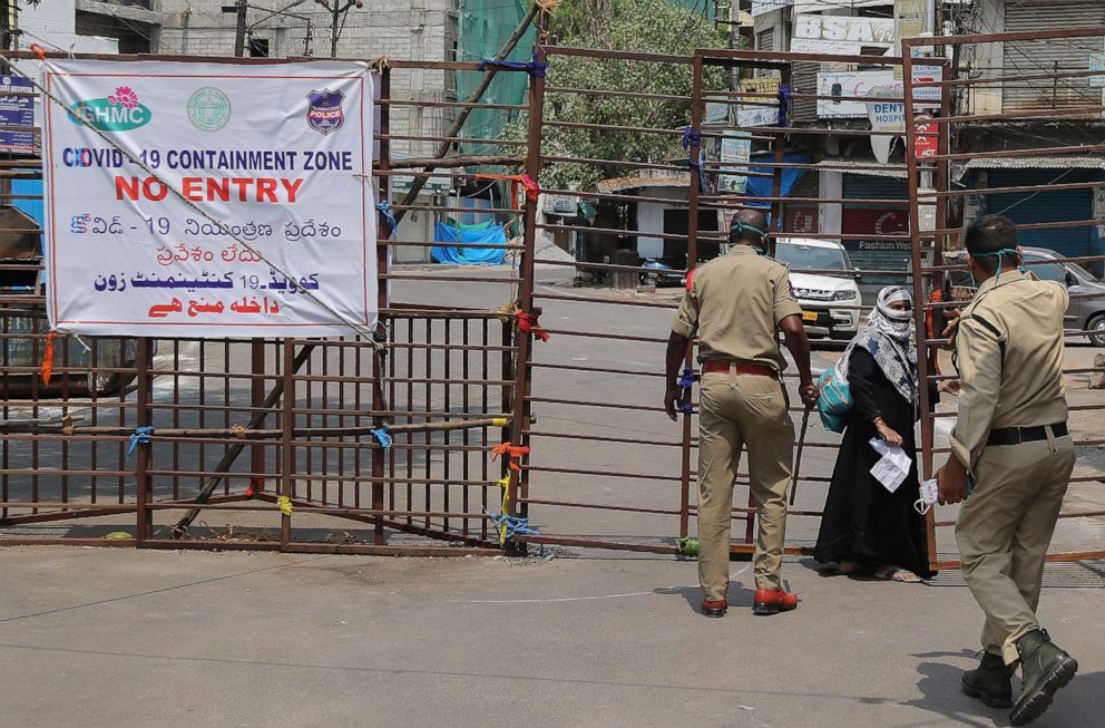 PHOTO: Policemen stop a woman from entering a containment zone during lockdown in Hyderabad, India, on April 14, 2020.