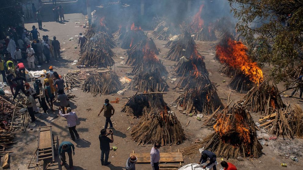 PHOTO: Multiple funeral pyres of victims of COVID-19 burn at a ground that has been converted into a crematorium for mass cremation in New Delhi, India, April 24, 2021.