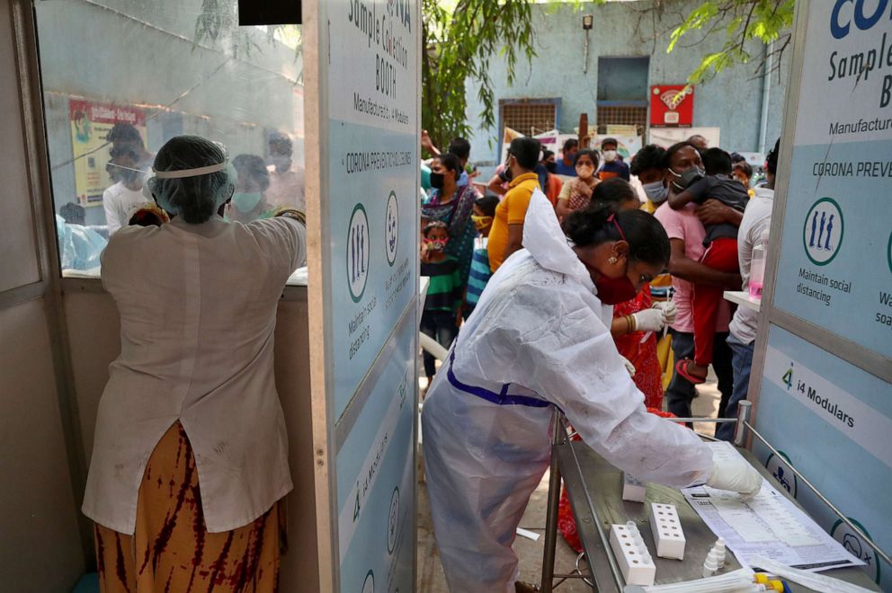 PHOTO: People wait their turn to get tested for COVID-19 in Hyderabad, India, April 25, 2021.