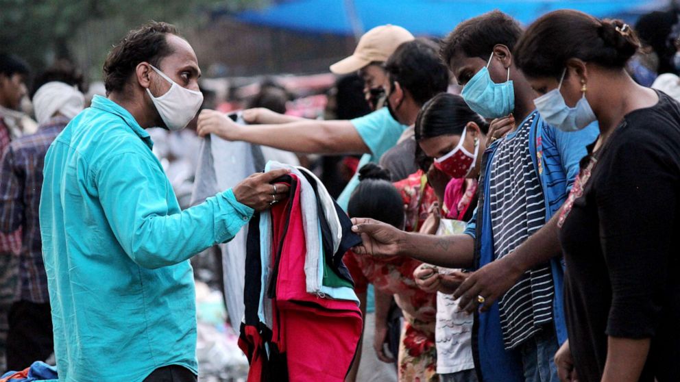 PHOTO: People jostle for space in a crowded street leading to no social distancing at a weekly market near DDU Marg in New Delhi on Sept. 18, 2020.