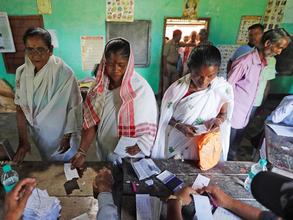 PHOTO: Women wait to collect their voter slips before casting their votes at a polling station during the first phase of general election in Majuli, a large river island in the Brahmaputra river, India April 11, 2019.