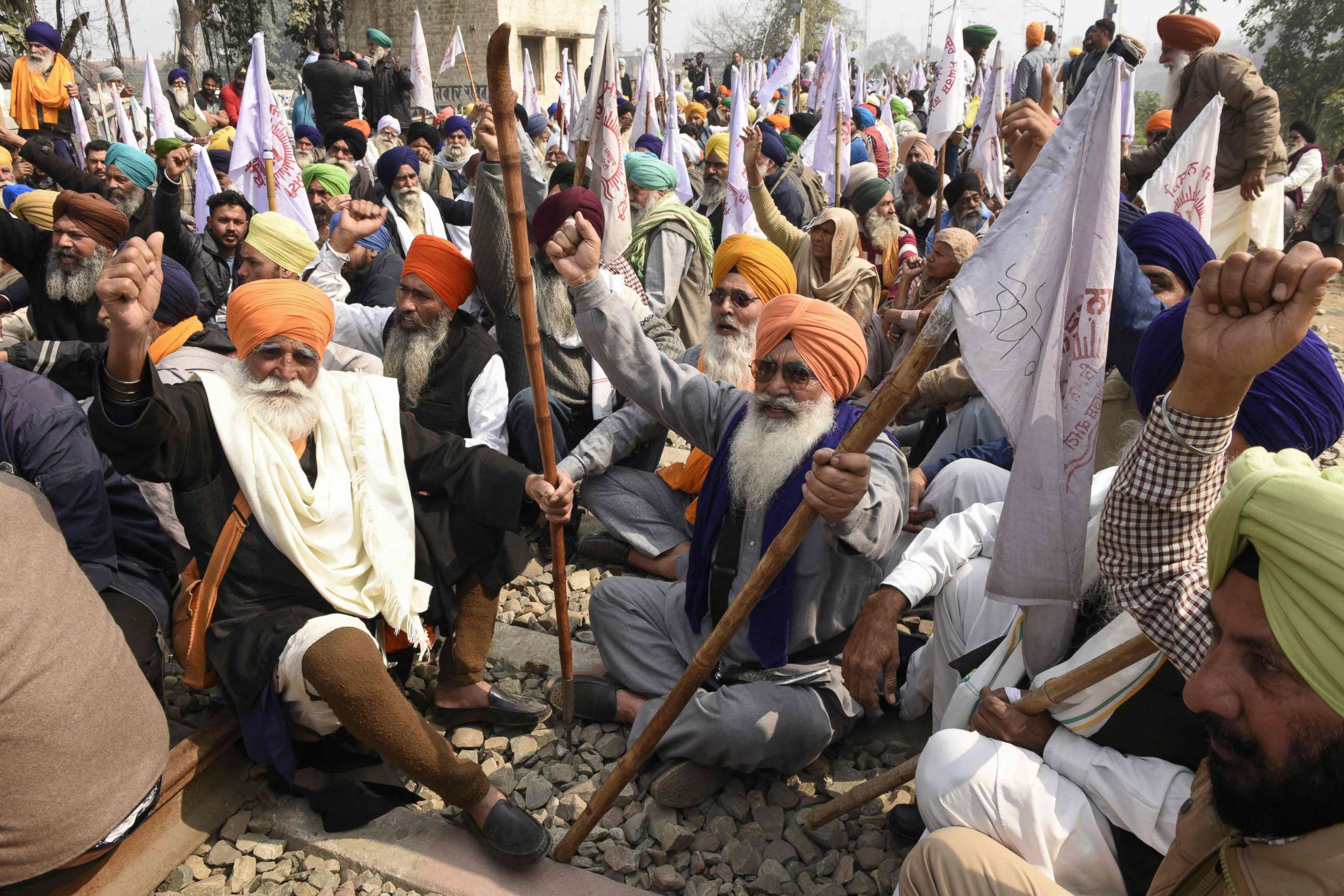 PHOTO:Farmers sit on railway tracks during a four-hour rail blockade as they continue their protest against the central government's recent agricultural reforms on the outskirts of Amritsar in India on Feb. 18, 2021.