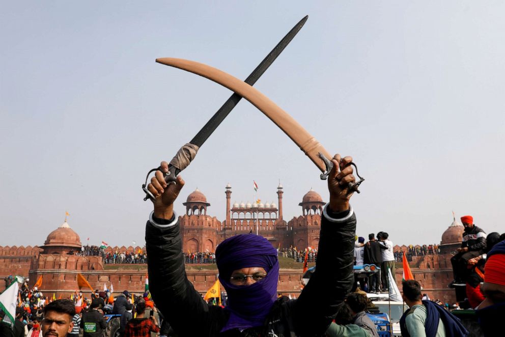 PHOTO: A farmer holds swords during a protest against farm laws introduced by the government at the historic Red Fort in New Delhi, Jan. 26, 2021.