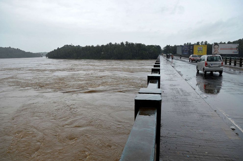 PHOTO: Vehicles drive on a bridge over the overflowing Chaliyar river in Kozhikode, India, Aug. 17, 2018.