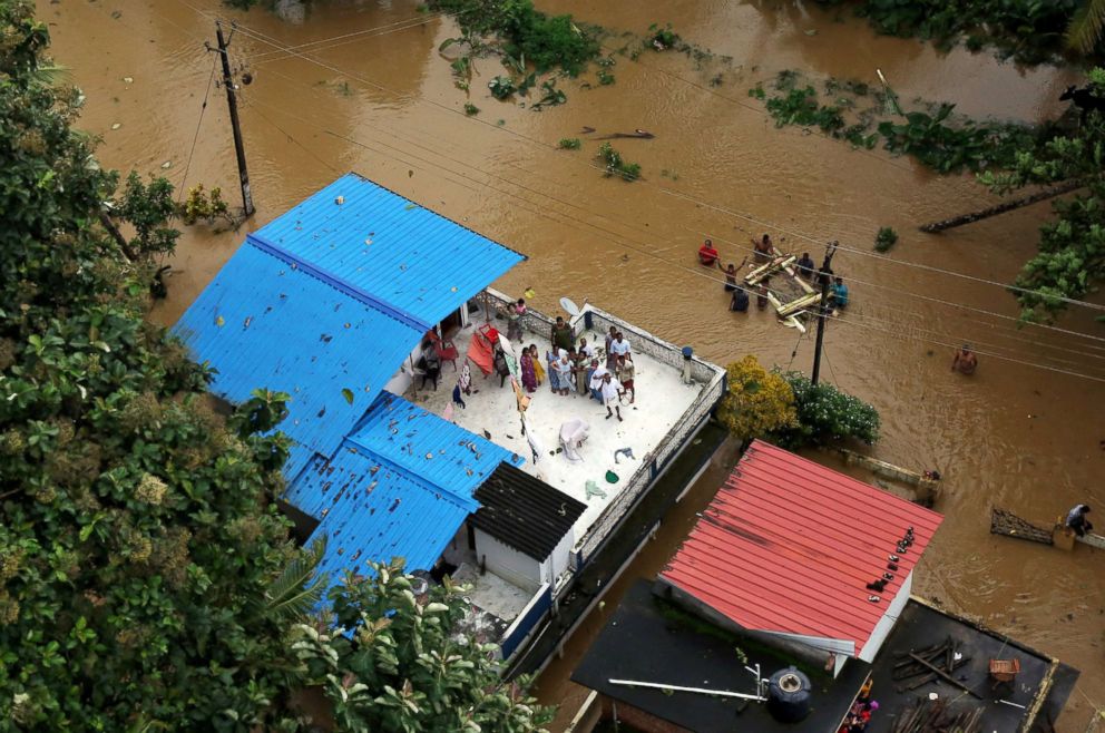 PHOTO: People wait for aid on the roof of their house at a flooded area in the southern state of Kerala, India, Aug. 17, 2018.