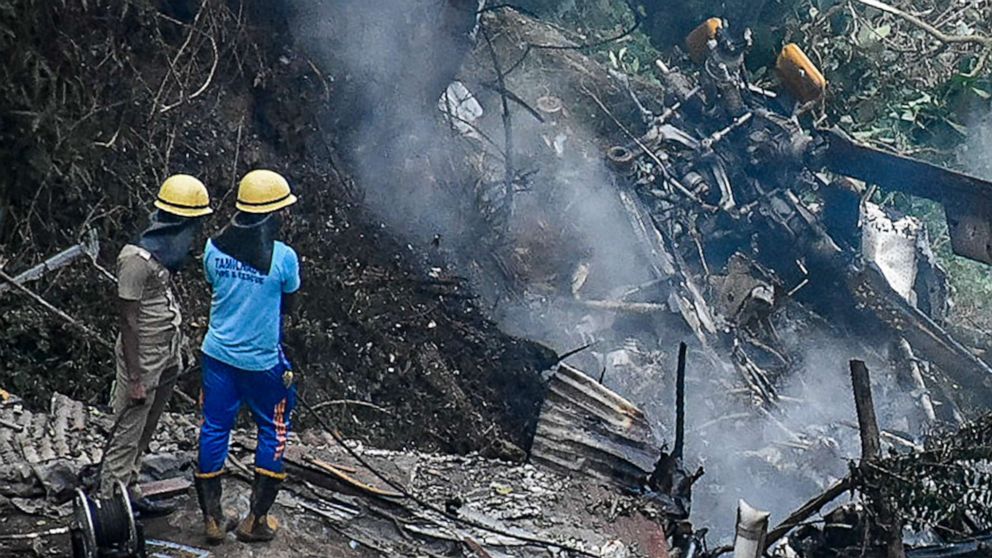 PHOTO: Firemen and rescue workers stand next to the debris of an IAF Mi-17V5 helicopter crash site in Coonoor, Tamil Nadu, on Dec. 8, 2021.