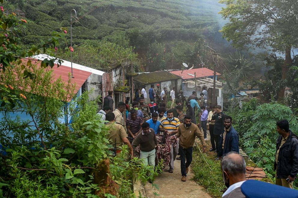 PHOTO: People help carry body of one of the victims from near the site of an IAF Mi-17V5 helicopter crash in Coonoor, Tamil Nadu, on Dec. 8, 2021.