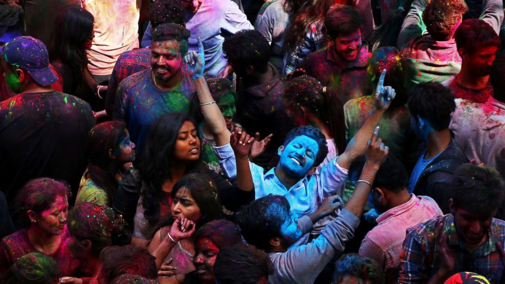PHOTO: Students with their faces smeared in colored powder dance as they celebrate the Hindu festival of Holi, heralding Spring, at a university campus in Chandigarh, India on March 1, 2018.