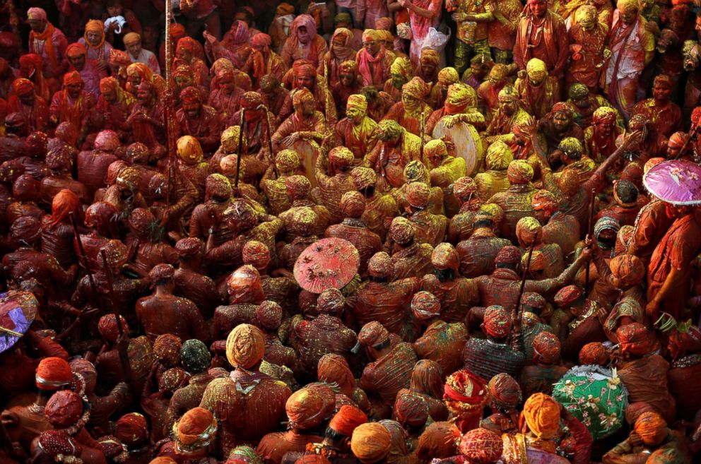 PHOTO: Hindu devotees take part in Holi festivities inside a temple in Nandgaon village, in Uttar Pradesh, India on Feb. 25, 2018. 
