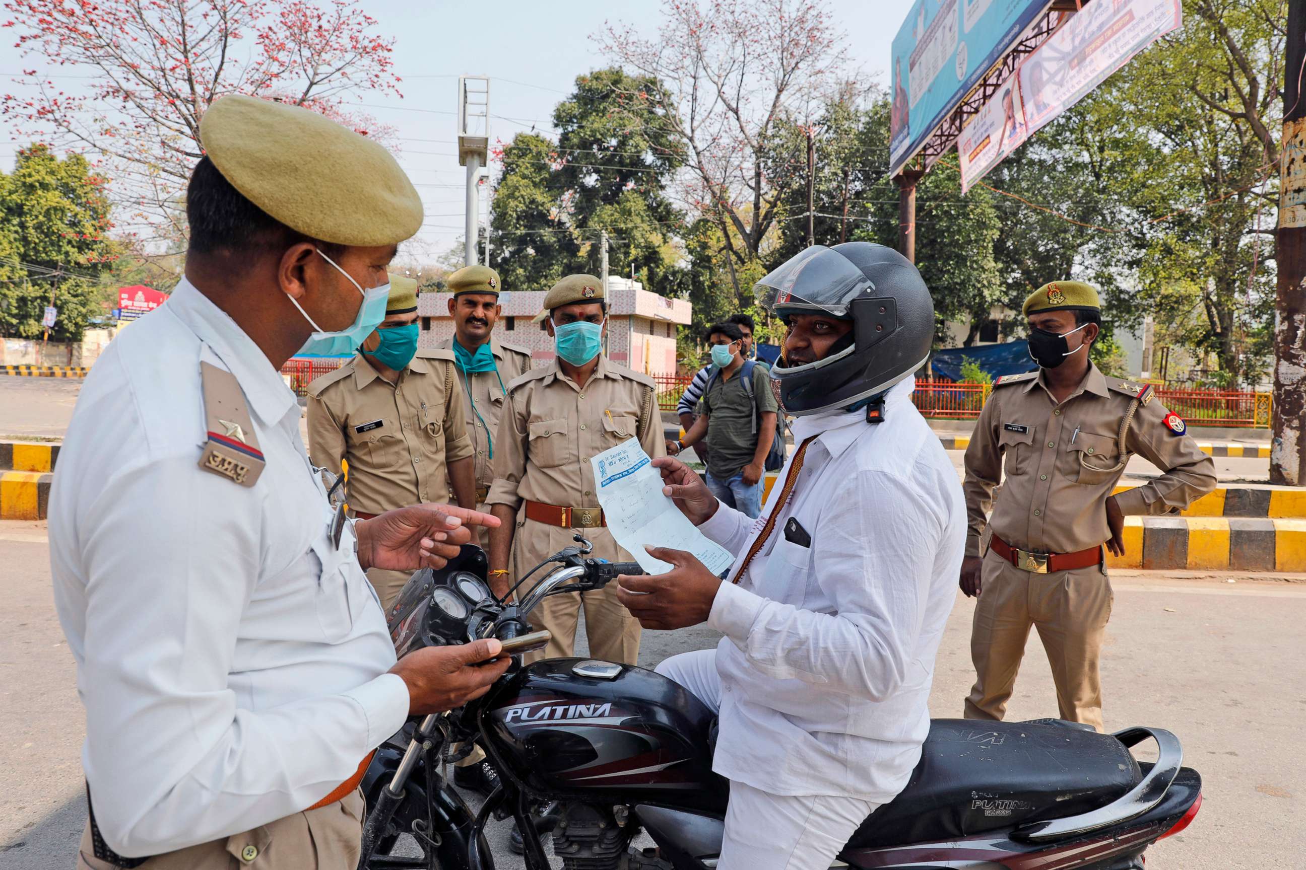 PHOTO: A commuter shows a doctor's prescription to policemen keeping guard during a complete lockdown amid growing concerns of coronavirus in Prayagraj, India, March 24, 2020.