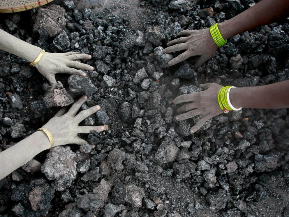 PHOTO: In this Monday, Dec. 14, 2015, file photo, Indian women use bare hands to pick reusable pieces from heaps of used coal discarded by a carbon factory in Gauhati, India.