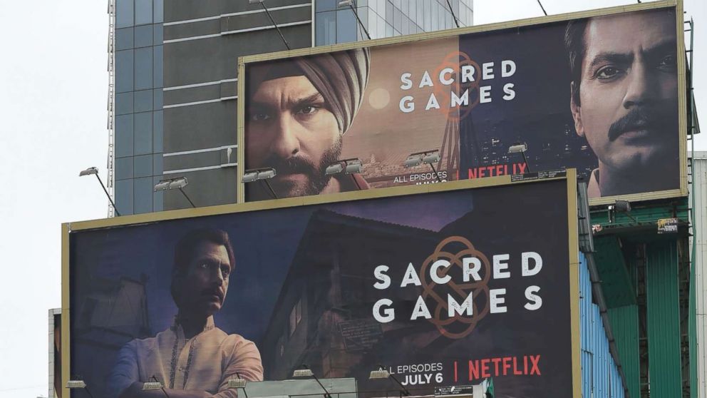 PHOTO: Indian commuters travel past large billboards for "Sacred Games", the upcoming Indian series on Netflix, in Mumbai in this July 4, 2018 file photo.