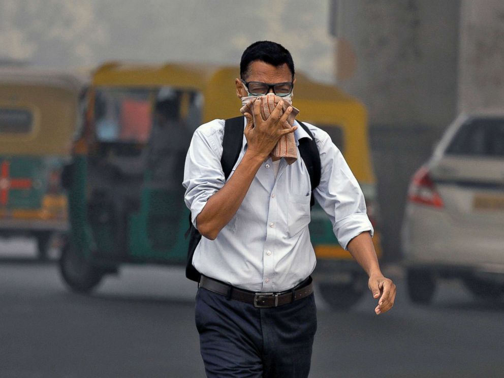 PHOTO: A man covers his face as he walks to work, in Delhi, India, Nov. 7, 2017.