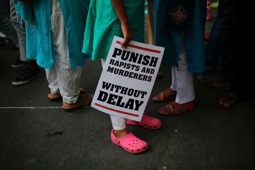PHOTO: Indian demonstrators display placards during a protest against two recently reported rape cases as they gather near the Parliament in New Delhi, India,  April 15, 2018. 