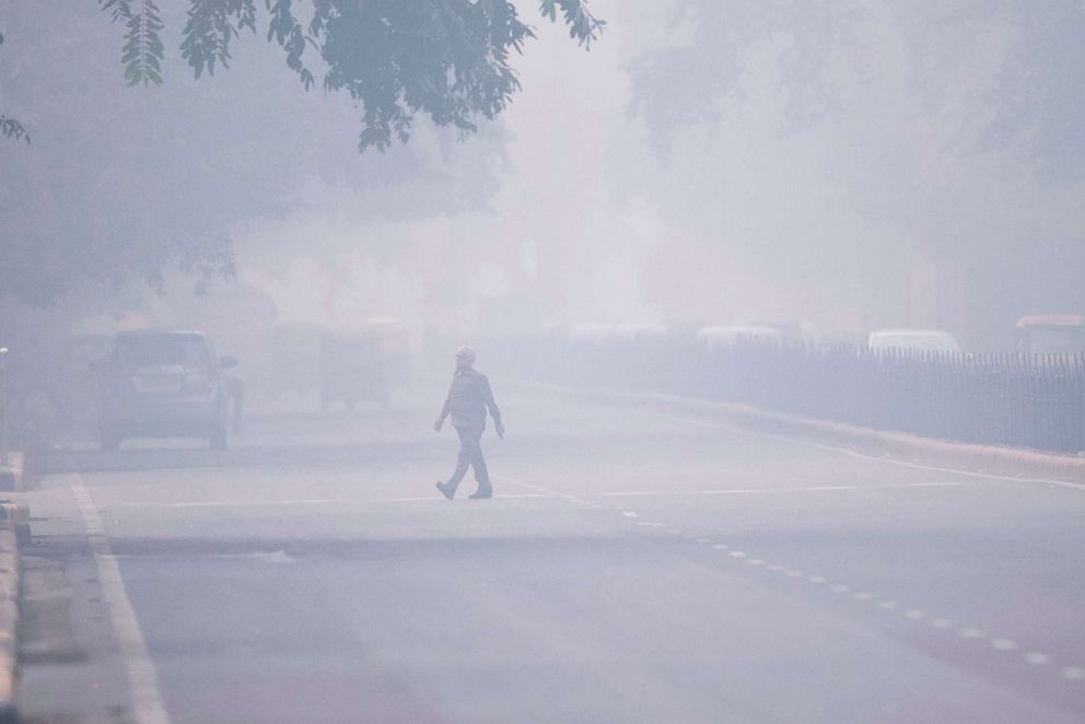 PHOTO: A man crosses a street in smoggy conditions in New Delhi on Nov. 4, 2019.