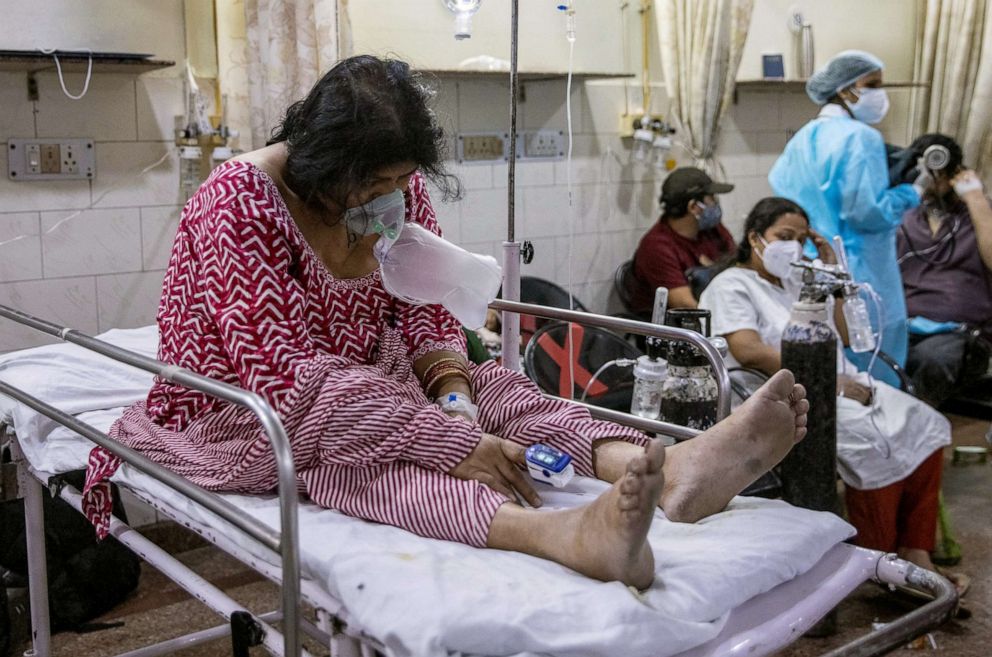 PHOTO: Pratibha Rohilla who is suffering from the coronavirus disease (COVID-19), sits on a bed inside the emergency room of Holy Family Hospital in New Delhi, India, May 1, 2021.