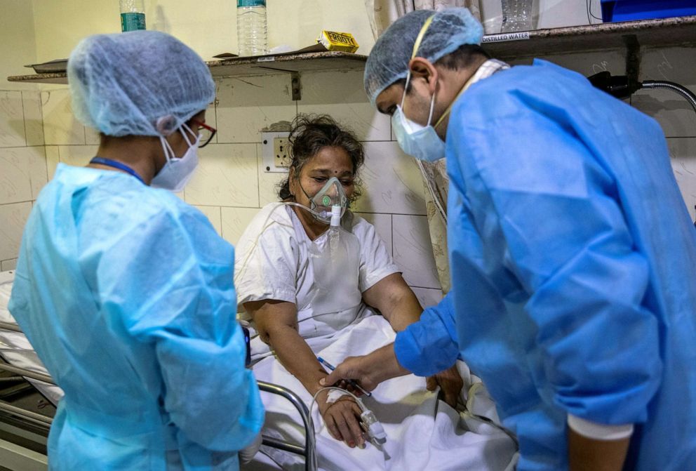 PHOTO: Rohan Aggarwal, 26, a resident doctor treating patients suffering from the coronavirus disease (COVID-19), tends to a patient inside the emergency room of Holy Family Hospital, during his 27-hour shift in New Delhi, India, May 1, 2021.