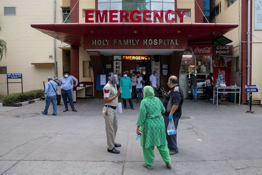 PHOTO: Relatives of a patient who is suffering from the coronavirus disease (COVID-19), argue with a police officer to admit him to the emergency ward at Holy Family Hospital in New Delhi, India, May 1, 2021.