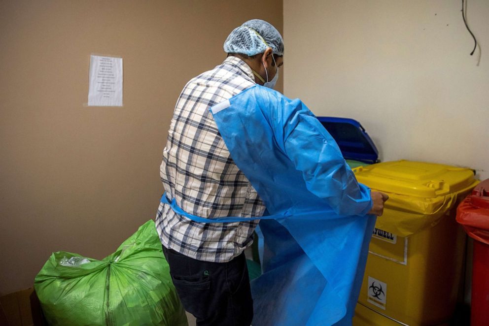 PHOTO: Rohan Aggarwal, 26, a resident doctor treating patients suffering from the coronavirus disease (COVID-19), takes off personal protective equipment during his 27-hour shift at Holy Family Hospital in New Delhi, India, May 2, 2021.