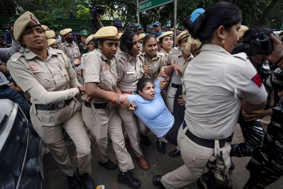 PHOTO: Sakshi Malik, in blue, an Indian wrestler who won a bronze medal at the 2016 Summer Olympics, is detained by the police during a protest demonstration at Jantar Mantar, an area near the Indian parliament, in New Delhi, May, 28, 2023.