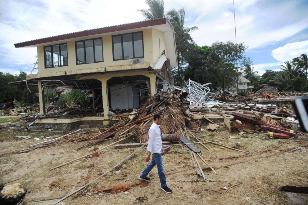 PHOTO: Indonesia's President Joko Widodo walks past debris at the Mutiara Carita Cottages in Carita in Banten province on Dec. 24, 2018, two days after a tsunami.