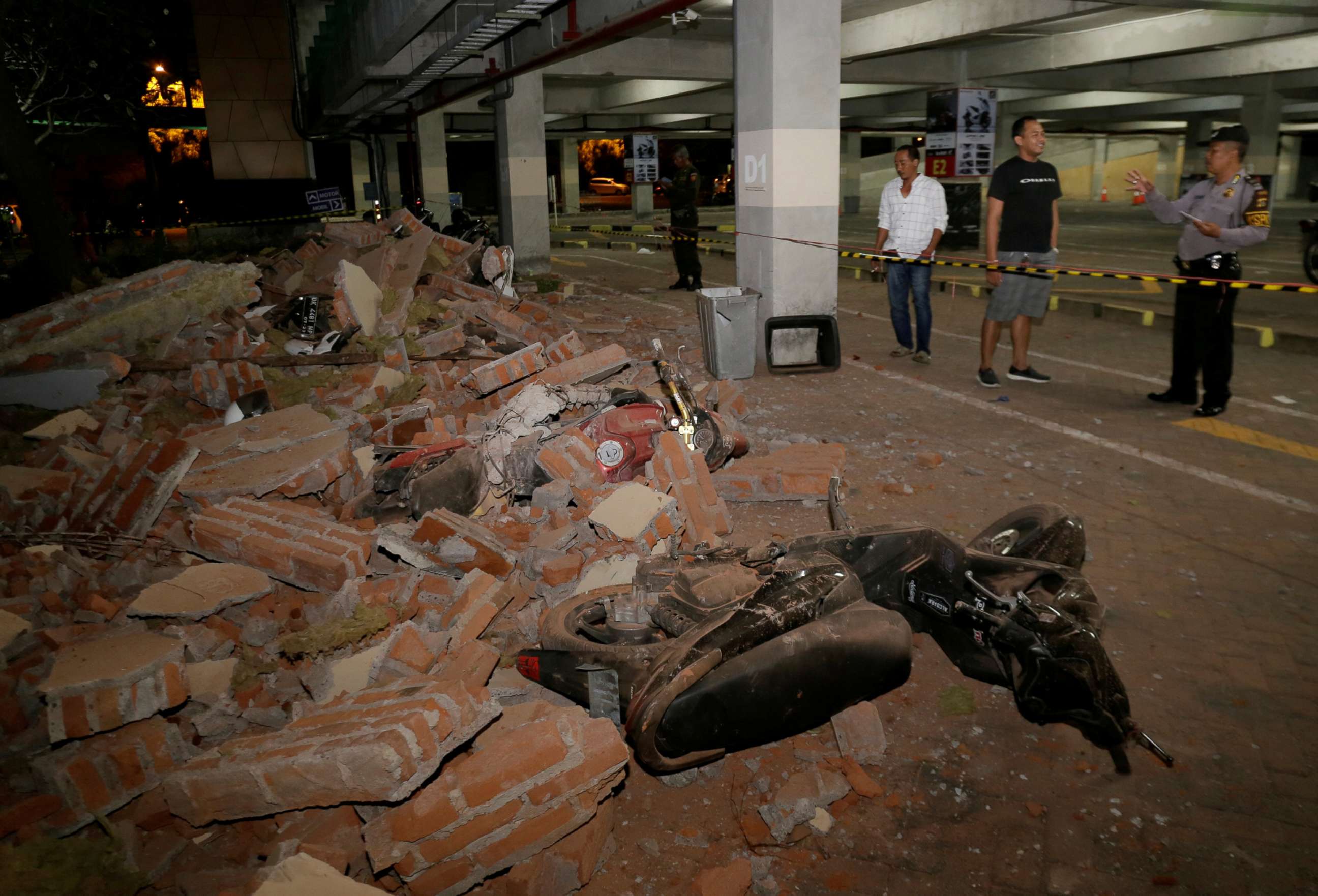 PHOTO: A policeman examines debris that fell and crushed parked motorbikes following a strong earthquake on nearby Lombok island, at a shopping center in Kuta, Bali, Indonesia, Aug. 5, 2018.