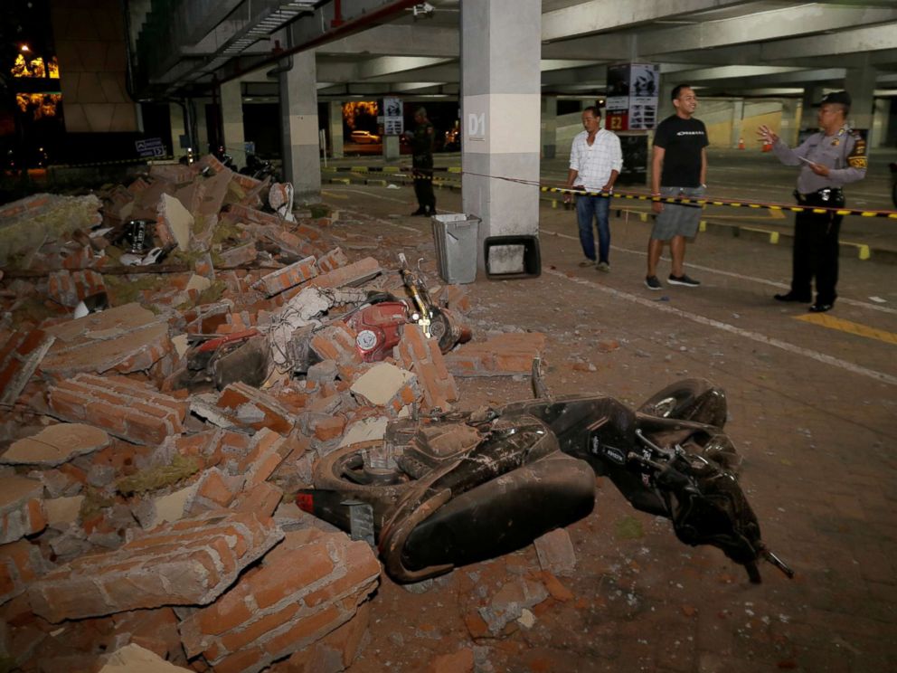 PHOTO: A policeman examines debris that fell and crushed parked motorbikes following a strong earthquake on nearby Lombok island, at a shopping center in Kuta, Bali, Indonesia, Aug   . 5, 2018.