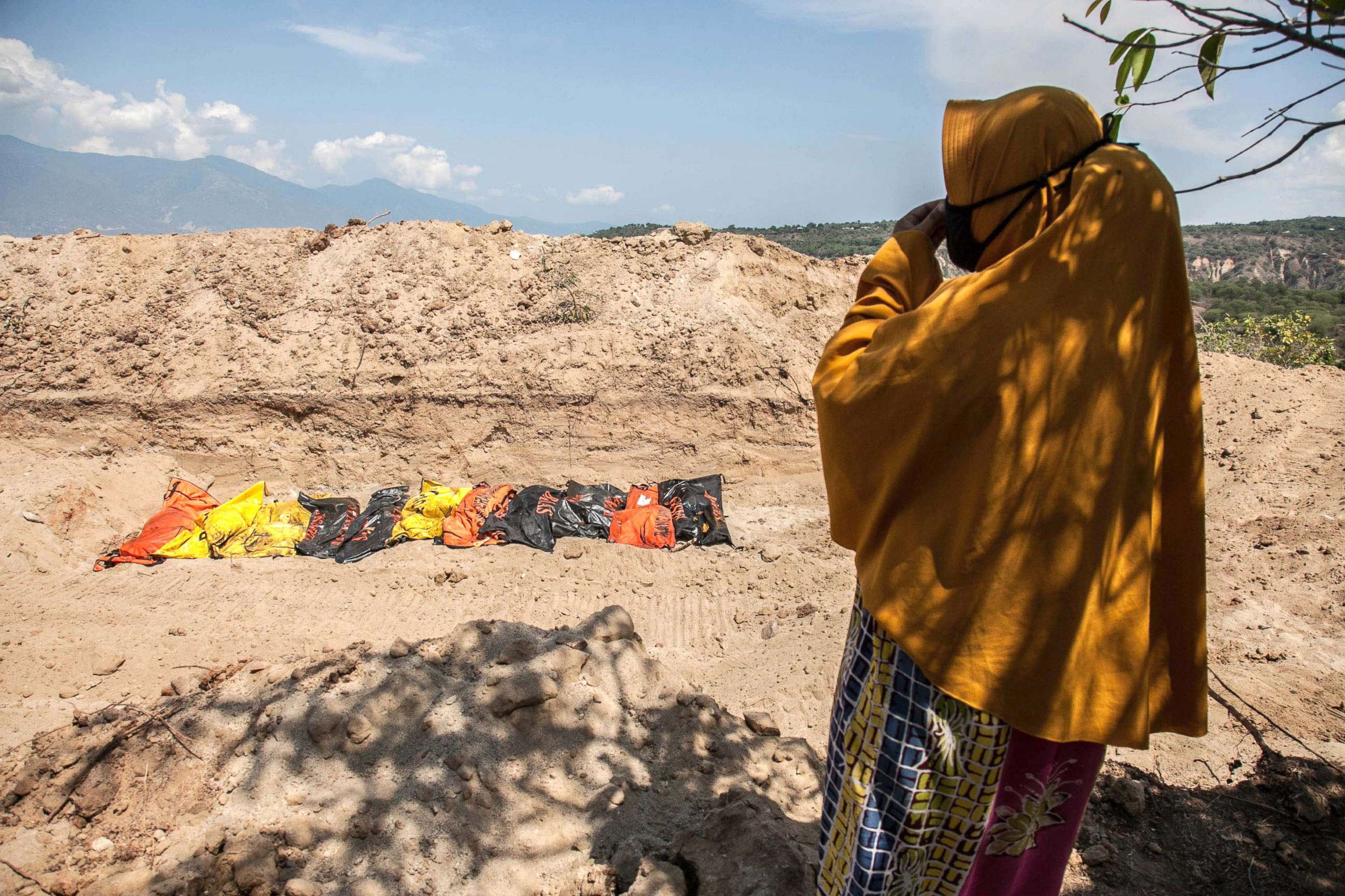 PHOTO: Susanti, stands near a mass burial field where her husband was buried, Oct. 3, 2018, after a earthquake and tsunami hit Palu, Central Sulawesi, Indonesia on Sept. 28.