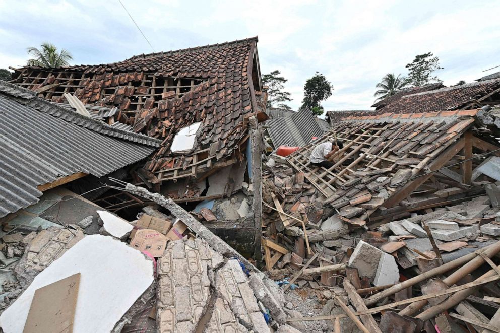 PHOTO: A man sifts through the rubble of a collapsed house in Cugenang, Cianjur on Nov. 23, 2022, following a 5.6-magnitude earthquake on November 21.