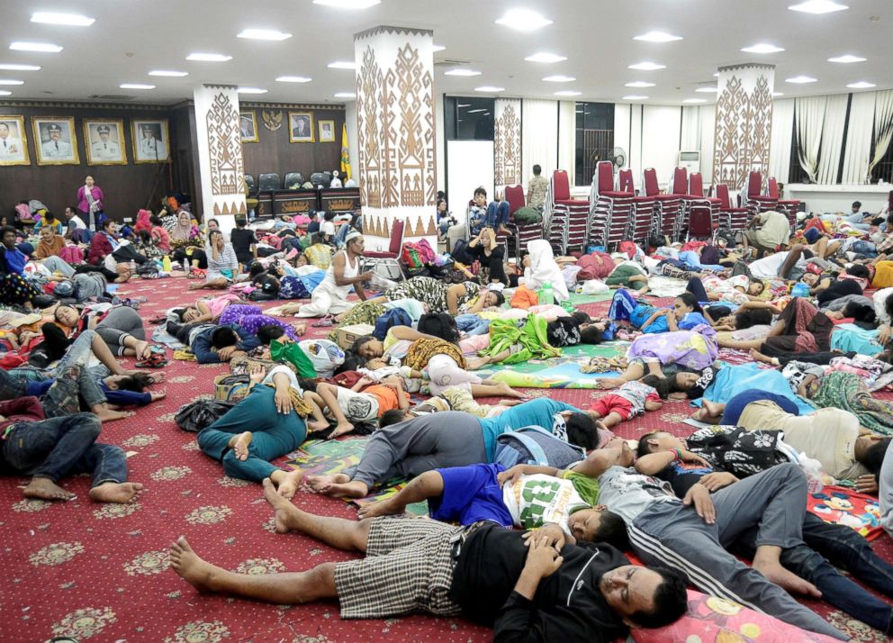 PHOTO: Residents, who lived at coast of Bandar Lampung, rest at a government building after they evacuated following a tsunami that hit Sunda strait in Lampung, Indonesia, in this Dec. 24, 2018, photo.