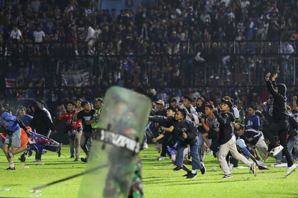 PHOTO: Soccer fans enter the pitch during a clash between supporters at Kanjuruhan Stadium in Malang, East Java, Indonesia, on Oct. 1, 2022.