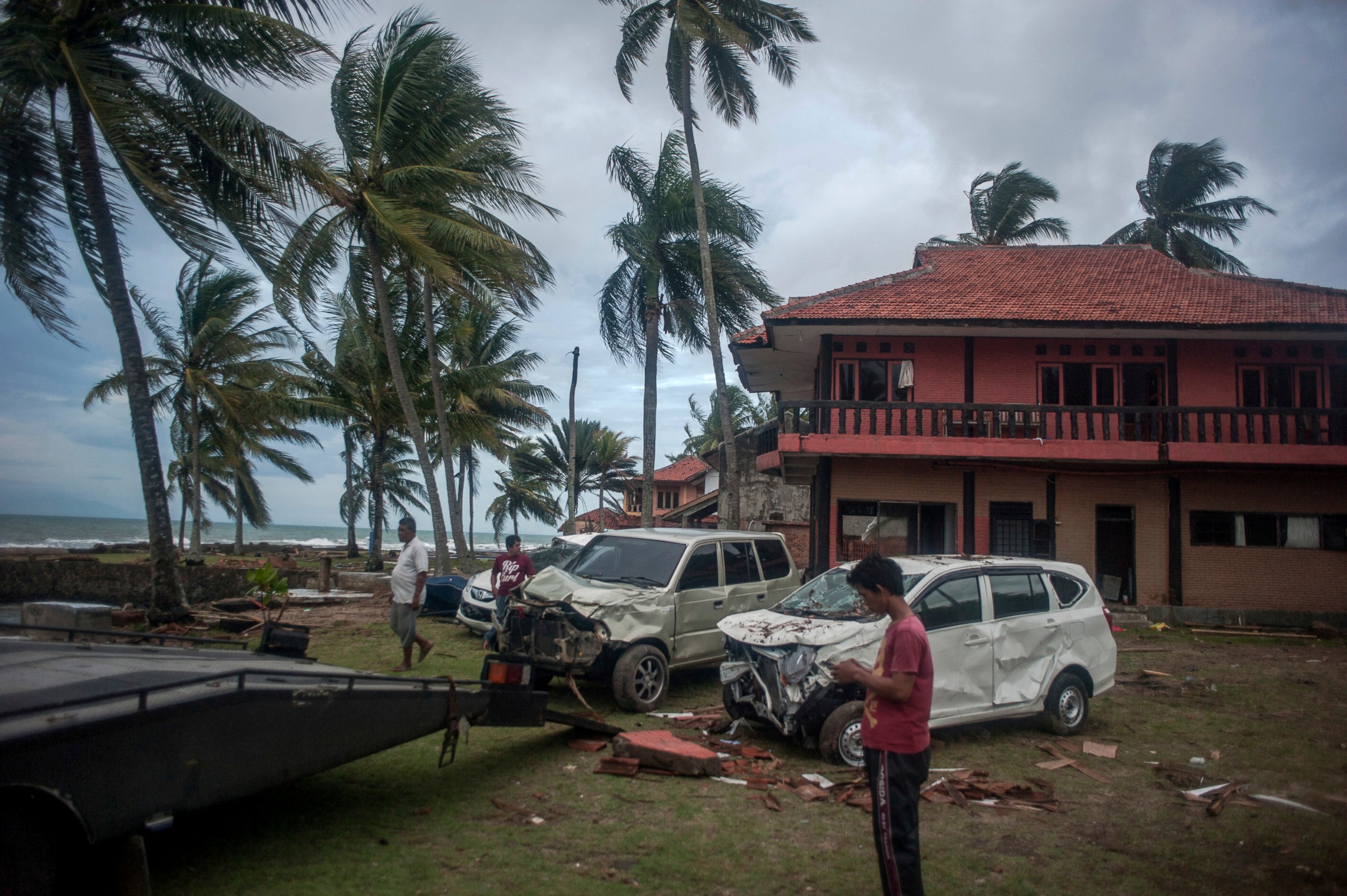 PHOTO: Owners reclaim their damaged cars from a resort affected by Saturday's tsunami in Carita, Indonesia, Tuesday, Dec. 25, 2018.