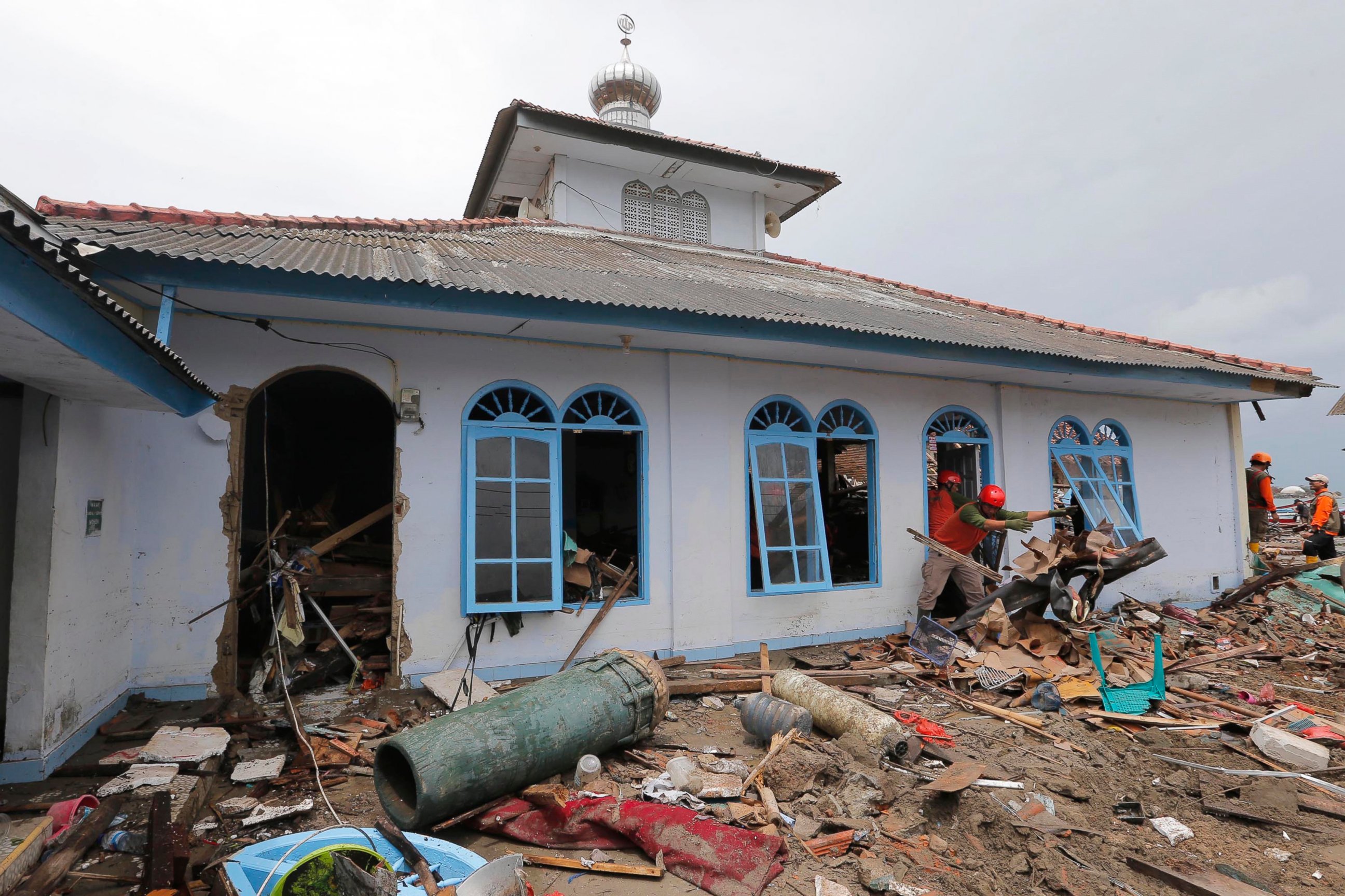 PHOTO: People clean up a mosque following the tsunami in Sumur, Indonesia, Tuesday, Dec. 25, 2018.